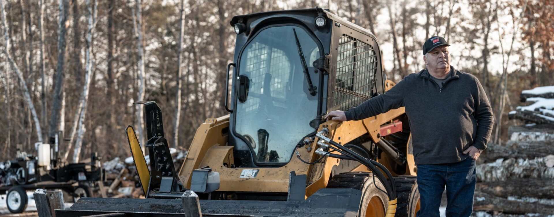 Halverson Wood Products owner standing next to a wood processor