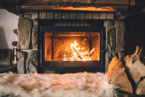 A roaring fire in an indoor fireplace.
