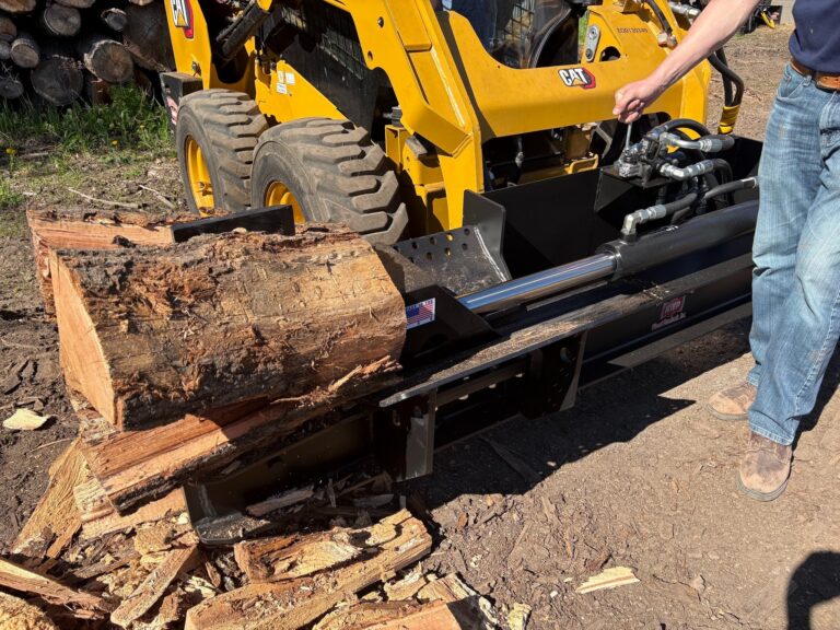 A man stands next to the HWP-135 as it processes a log.